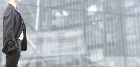 Businessman follows and tie standing relaxedの写真素材