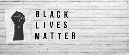 Black Lives Matter. Illustration with words written on paper posters on white brick wall background....