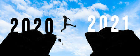 Silhouette woman jump between 2020 and 2021 years with sunset background, Success new year concept.