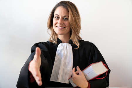 Justice, lawyer reaches out with a smile - Young beautiful caucasian womanの写真素材