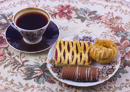 ffee and a plate of biscuits on colored tableclothsの写真素材