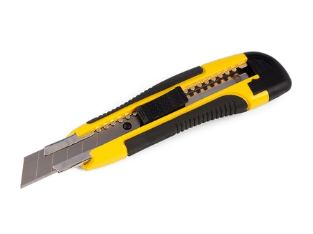 Yellow stationery knife on a white backgroundの写真素材