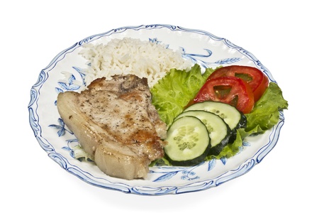 meat with vegetables and rice on white plateの写真素材