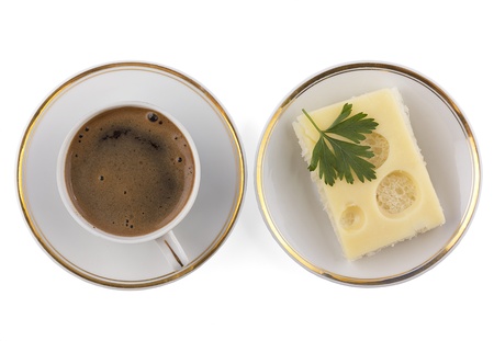 A cup of coffee and a sandwich on a plateの写真素材