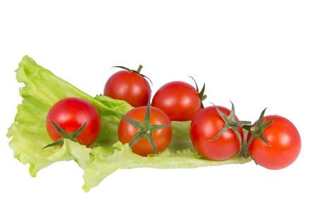 Red cherry tomato and salad on white backgroundの写真素材