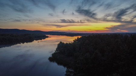 the Dnieper river flows among the forests and fields, ukraine filming from a drone. view from aboveの写真素材