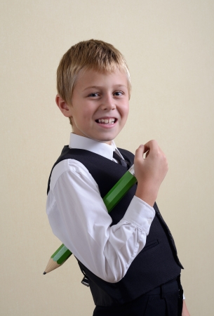 brave schoolboy with big pencilの写真素材