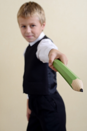 brave schoolboy with big pencilの写真素材