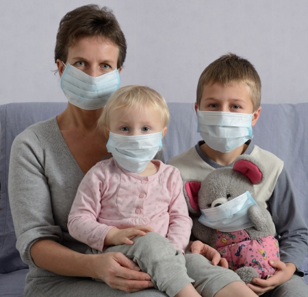 Family in protective masksの写真素材