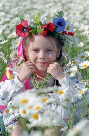 smiling ukrainian girl on chamomile fieldの写真素材