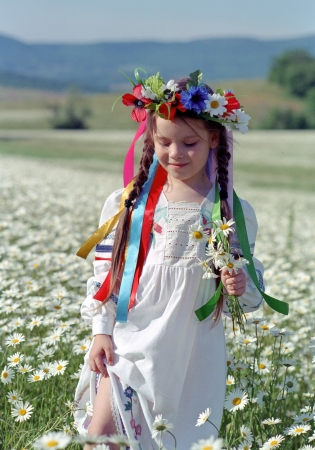 smiling ukrainian girl on chamomile fieldの写真素材