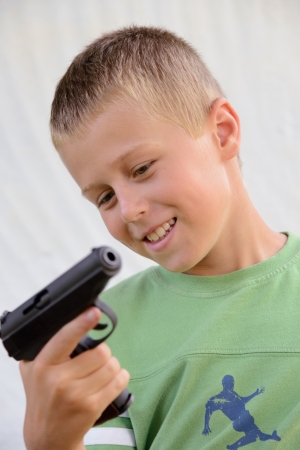 schoolboy with gunの写真素材