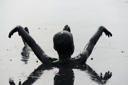 man lying in the mudの写真素材