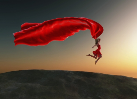 woman jumping with a red tissue の写真素材
