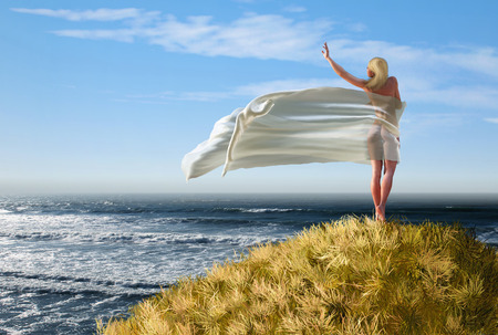 woman with a white tissue on a mountain topの写真素材