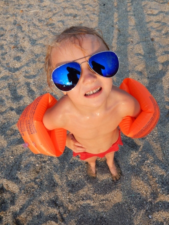 funny girl in sunglasses on summer beachの写真素材