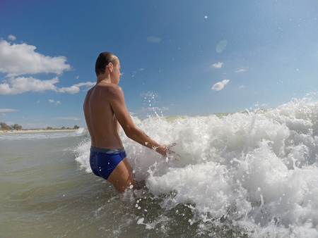 boy playing in the sea wavesの写真素材