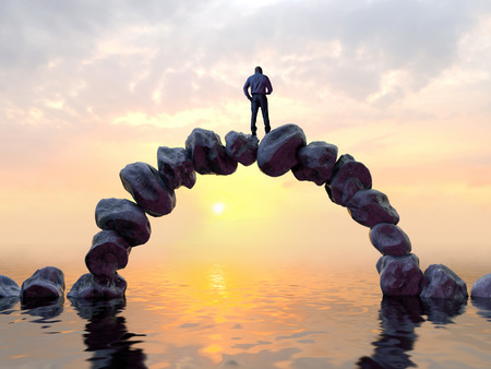 man stands on top of a stone bridgeの写真素材