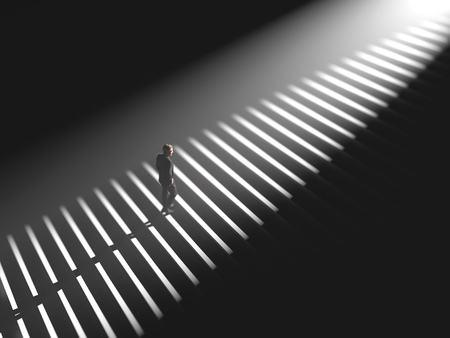 man climbs the stairs in the lightの写真素材