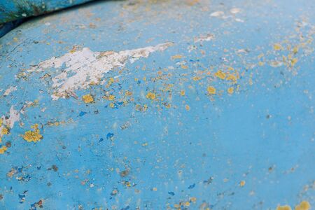 Cracked blue paint with yellow inserts and scratches