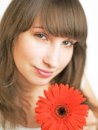 Beautiful girl holding red herberaの写真素材