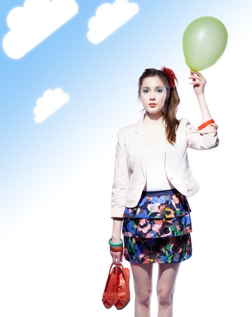 Beautiful girl holding a balloon in one hand and red shoes in another, blue gradient background with clouds