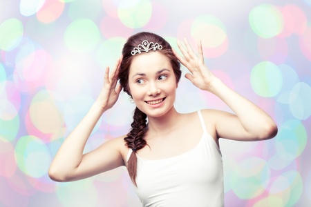 Beautiful girl admiring her diamond tiara の写真素材