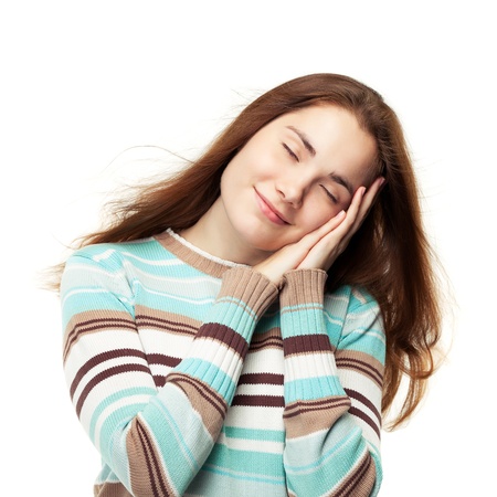 Young beautiful girl pretend sleeping and having sweet dreams, isolated on whiteの写真素材