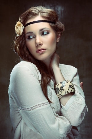 Glamour hippie girl posing on grunge backgroundの写真素材