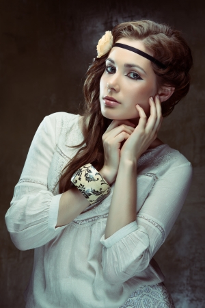 Pretty hippie girl posing on grunge backgroundの写真素材