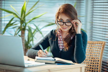 Beautiful student girl n glasses studying