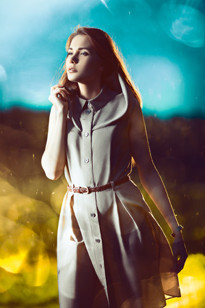 Young beautiful woman with long hair on sparkling backgroundの写真素材
