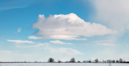 Beautiful cloudscape and white clear surface of snow till flat horizonの写真素材