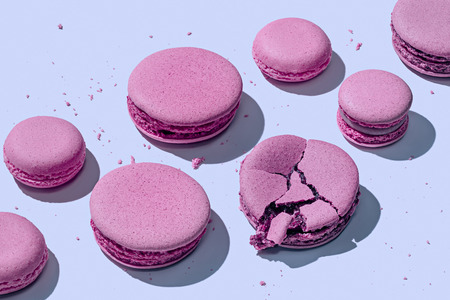 Delicious lavender macarons on pastel blue background with shadowsの写真素材