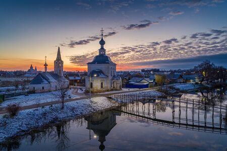 Russian Town Suzdal at sunset. Church of the Epiphany and the bridge over the Kamenka river  the...