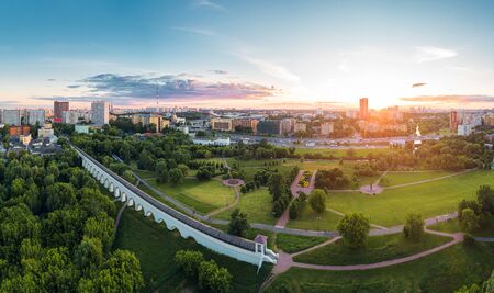 Aerial view of Moscow over the Rostokino Aqueduct (Millionny Bridge) and the park around it at summer sunset. There are distant VDNKh park and Ostankino towerの写真素材