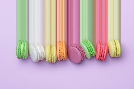 Top view of colorful macaron biscuits in a row on pastel color block background, flat lay, pixel stretchの写真素材