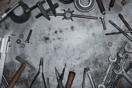 Old hand tools on metal grunge surface, flat layの写真素材