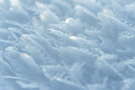 Thin crust of ice over snow, hoarfrost. texture or background.