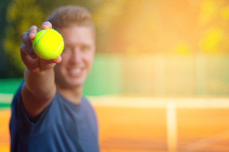 Man show tennis close-up ballの写真素材