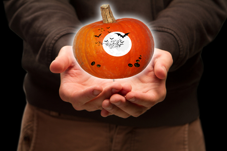 the guy is holding a pumpkinの写真素材