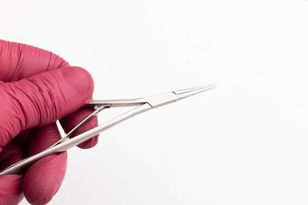 Dentist tools. Teethcare, dental health concept. White background with dentist hand in red glow