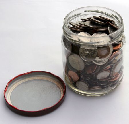 change jar full of change on white