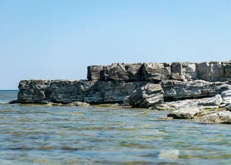sunny summer landscape with dolomite rocks by the sea, beautiful view of wild romantic coastal cliff landscape at the Baltic Sea at Tagalaht Bay, Saremma Island, Estoniaの写真素材