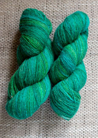 photo with two green wool yarn skeins, handicraft conceptの写真素材