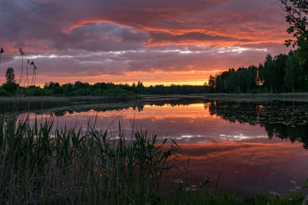 Beautiful sunset with reflections on the lake in the background. A wonderful place of strength and energy, peace, harmony and silence.
Sunset with red to dark blue colors, Lielais Ansis, Rubene, Latviaの写真素材
