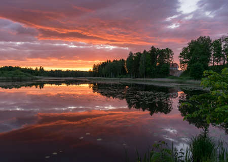 Beautiful sunset with reflections on the lake in the background. A wonderful place of strength and energy, peace, harmony and silence.
Sunset with red to dark blue colors, Lielais Ansis, Rubene, Latviaの写真素材