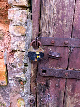 old wooden door fragments in sandstone wall cover cellars dug in sandstone rockの写真素材