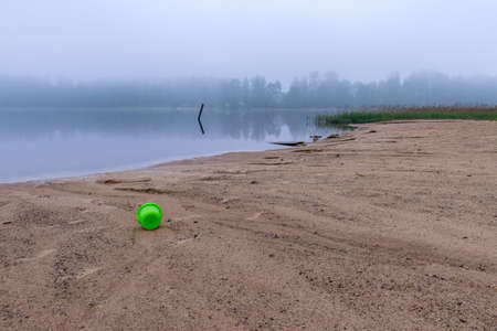 landscape with sandy beach after heavy rain, white fog on the lake, fuzzy contoursの写真素材