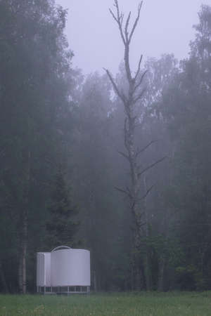 summer fog landscape in the morning with a picnic place on the lake shoreの写真素材